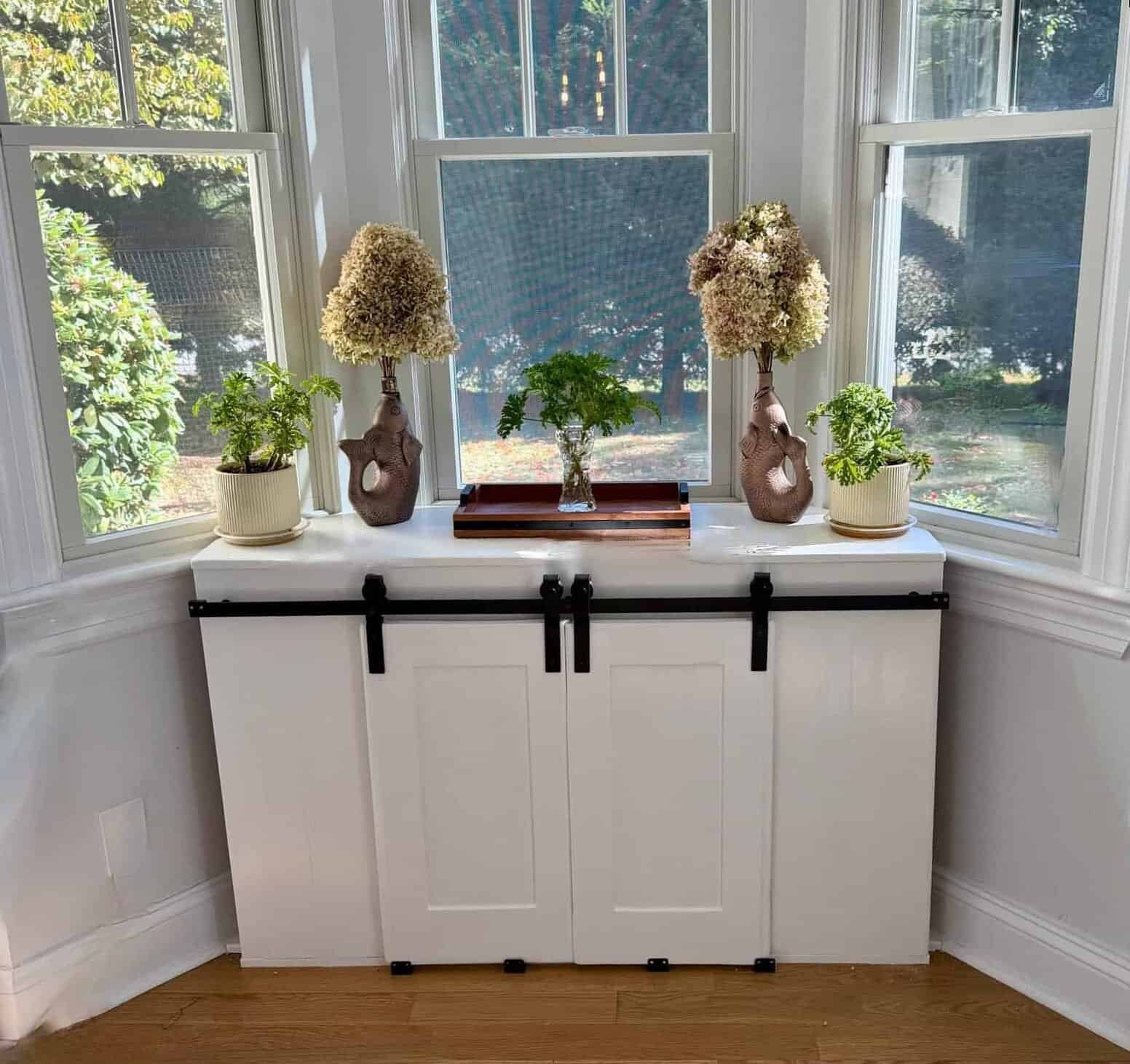 Finished white bay window cabinet with sliding doors
